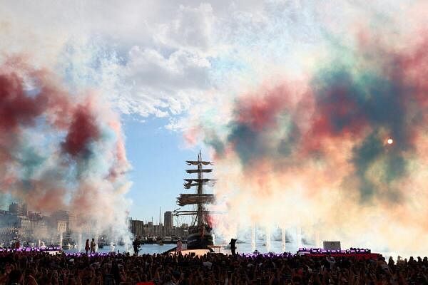 General view of colored smoke as French rapper Julien Mari aka Jul is seen after the Olympic Flame was lit at the Old Port ahead of the Paris Olympics 2024.