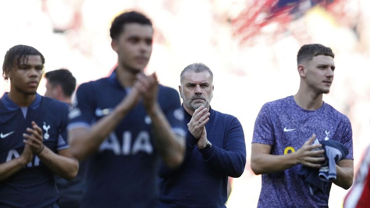 Tottenham Hotspur manager Ange Postecoglou and the players applaud fans after a match.