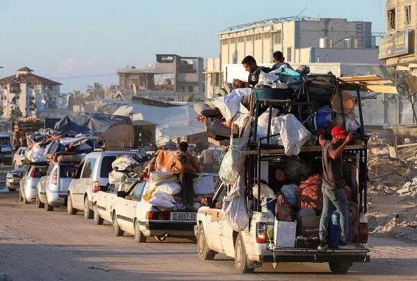Displaced Palestinians who fled Rafah, ahead of a threatened Israeli assault, travel in Khan Younis.