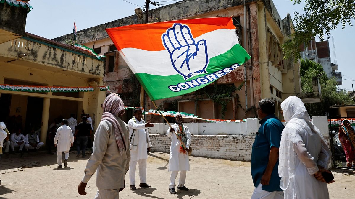 A supporter waves the flag of the Congress party before the arrival of Rahul Gandhi in Raebareli, Uttar Pradesh.