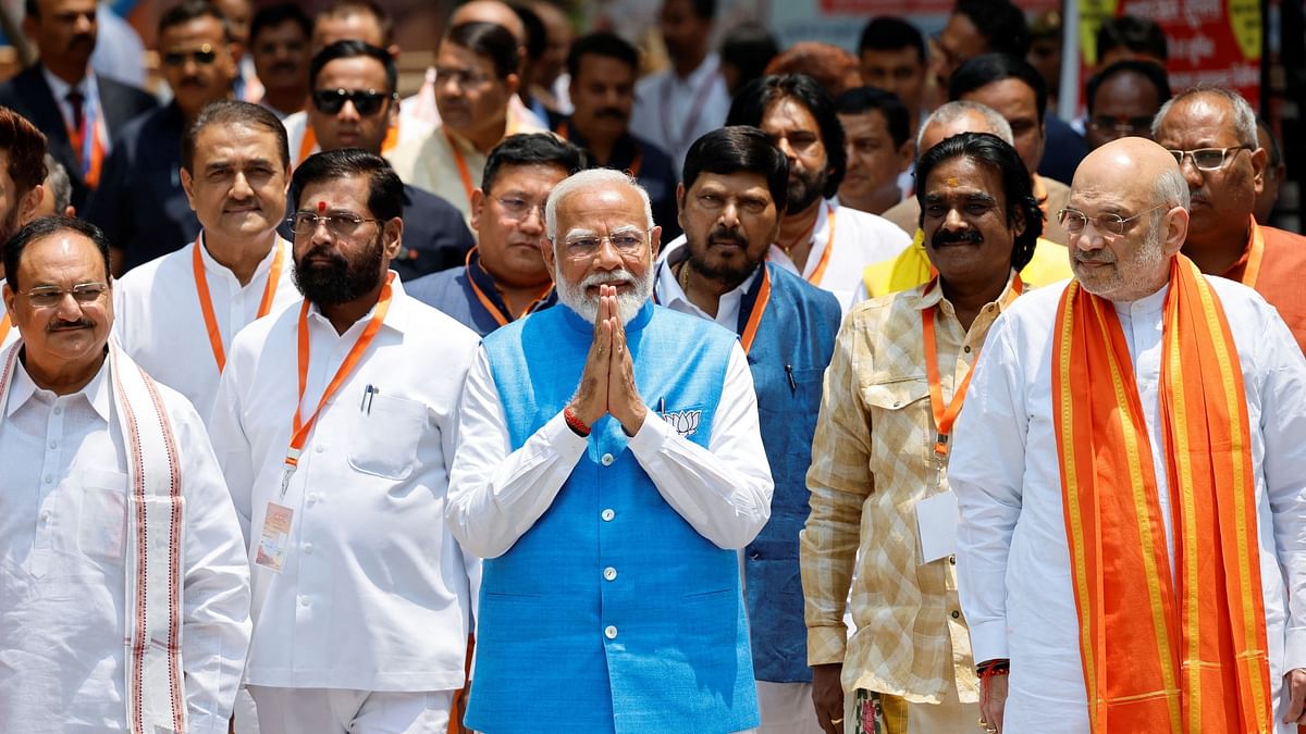 Prime Minister Narendra Modi walks with his party leaders on the day he files his nomination papers for the general elections in Varanasi.