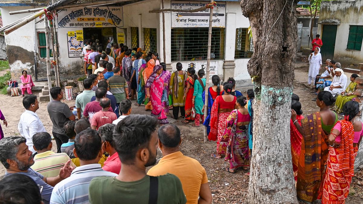 People wait in queues to cast their votes during the fifth phase of Lok Sabha elections, in Hooghly, West Bengal.