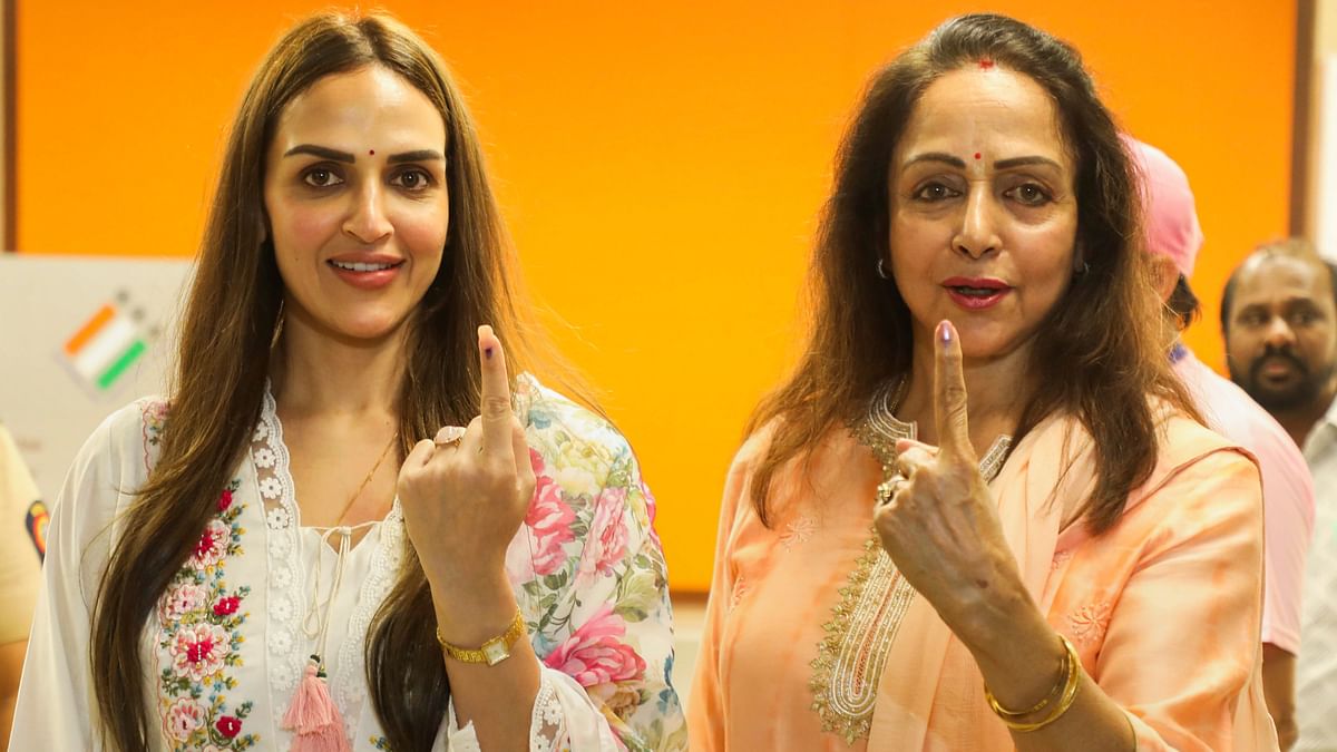 Actors Hema Malini and her daughter Esha Deol show their inked fingers after casting votes for the fifth phase of Lok Sabha elections, in Mumbai.