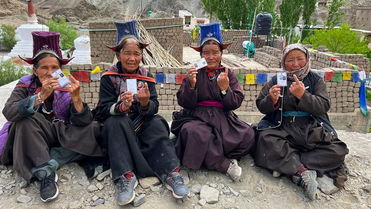 People show their inked fingers after casting their votes during the fifth phase of Lok Sabha elections, in Ladakh.