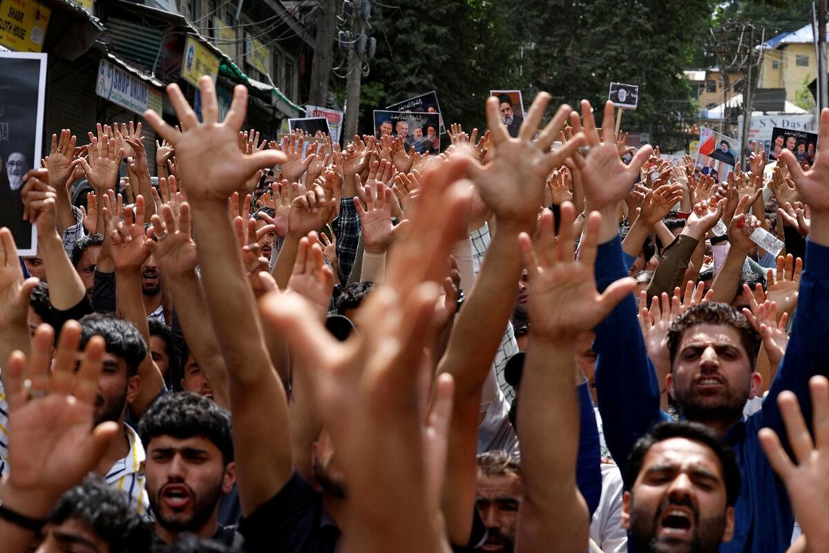 Shiite Muslims react as they attend a commemoration ceremony of late Iranian President Ebrahim Raisi, in Budgam on the outskirts of Srinagar May 24, 2024.