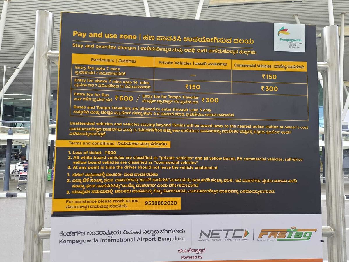 A notice board specifies the entry fees for private vehicles and cabs at the arrival zone of the Kempegowda International Airport in Bengaluru on Monday. 