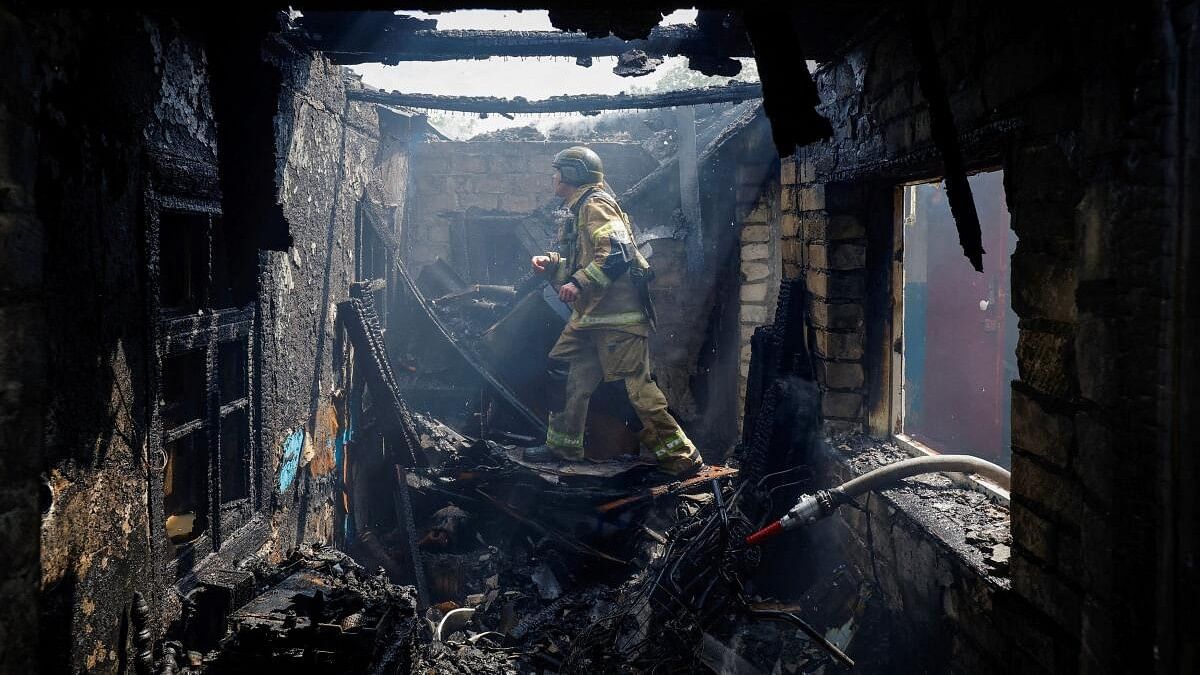 A firefighter works amid debris of a destroyed house in a residential area following what local Russian-installed authorities say was a Ukrainian military strike in the course of Russia-Ukraine conflict, in Makiivka (Makeyevka), Donetsk region, Russian-controlled Ukraine, May 22, 2024.