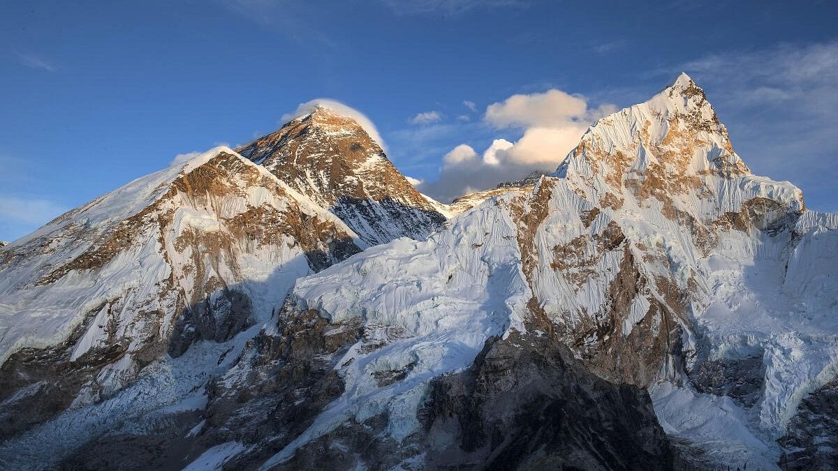 Ten Nepali mountain guides scale Mount Everest as it opens to climbers for spring season