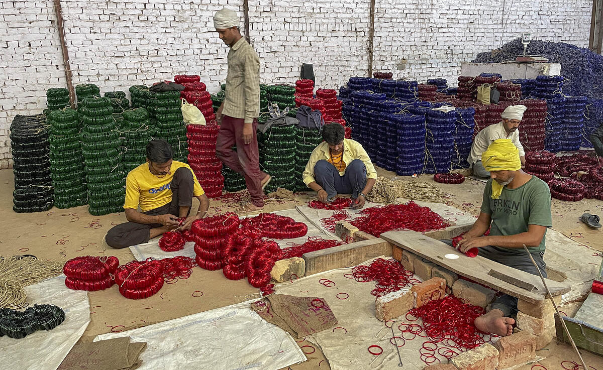 Bangle workers work at a factory, in Firozabad. 