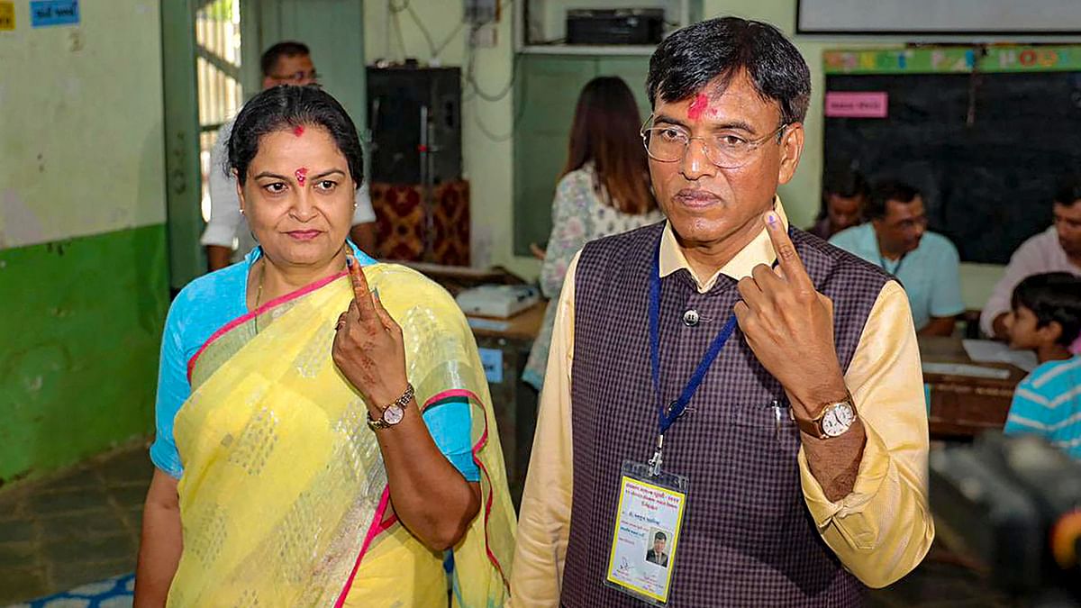 Union Minister Mansukh L Mandaviya and his wife Neeta show their inked fingers after casting their vote during the third phase of Lok Sabha polls, in Bhavnagar, Gujarat.