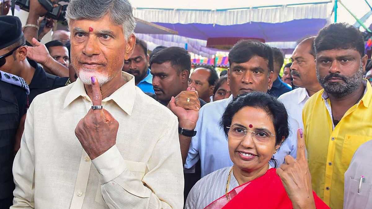 Telugu Desam Party Chief N Chandrababu Naidu and wife Nara Bhuvaneshwari show their inked finger after casting vote during Lok Sabha elections, in Undavalli, Andhra Pradesh.