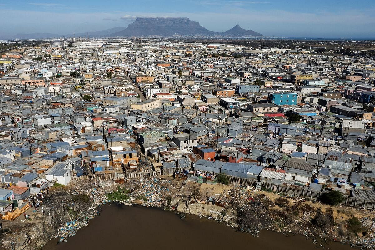 A drone view shows shacks adjacent to a polluted dam in the high-density suburb of Du Noon ahead of the general election in Cape Town, South Africa May 24, 2024.