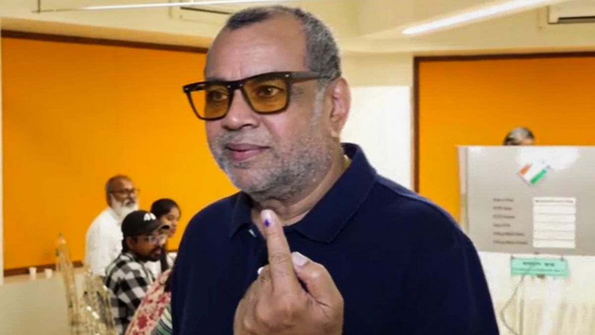 Bollywood actor Paresh Rawal shows his inked finger after casting his vote during the fifth phase of Lok Sabha elections, in Mumbai.