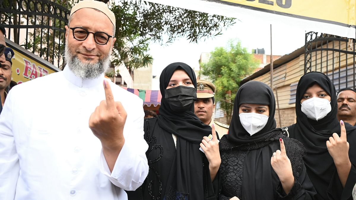 AIMIM's Asaduddin Owaisi shows his inked finger along with his family members after casting his vote at Vattapally polling station during the fourth phase of Lok Sabha polls, in Hyderabad.