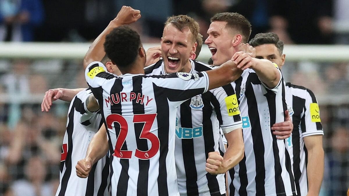 Newcastle United's Dan Burn, Sven Botman and Jacob Murphy celebrate after qualifying for the Champions League.