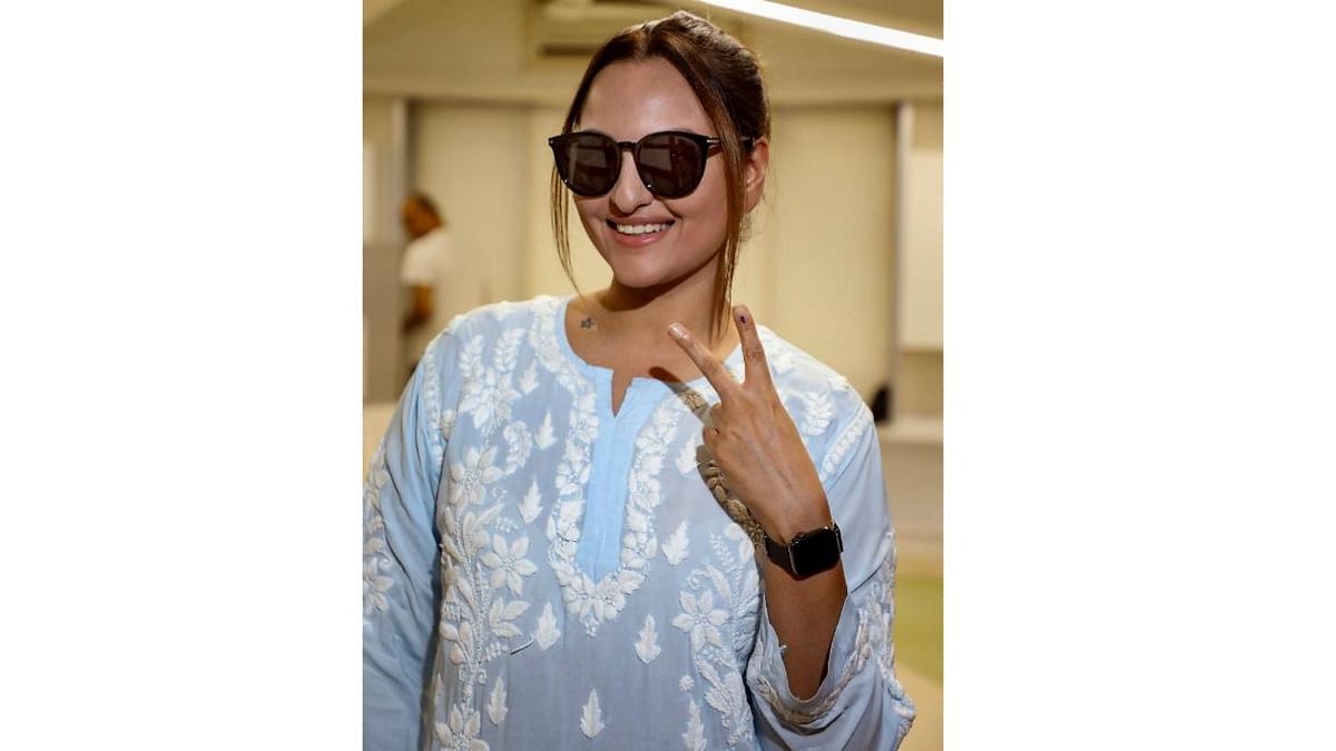 Bollywood actor Sonakshi Sinha poses as she shows her ink marked finger after casting her vote at a polling booth during the fifth phase of Lok Sabha elections, in Mumbai.