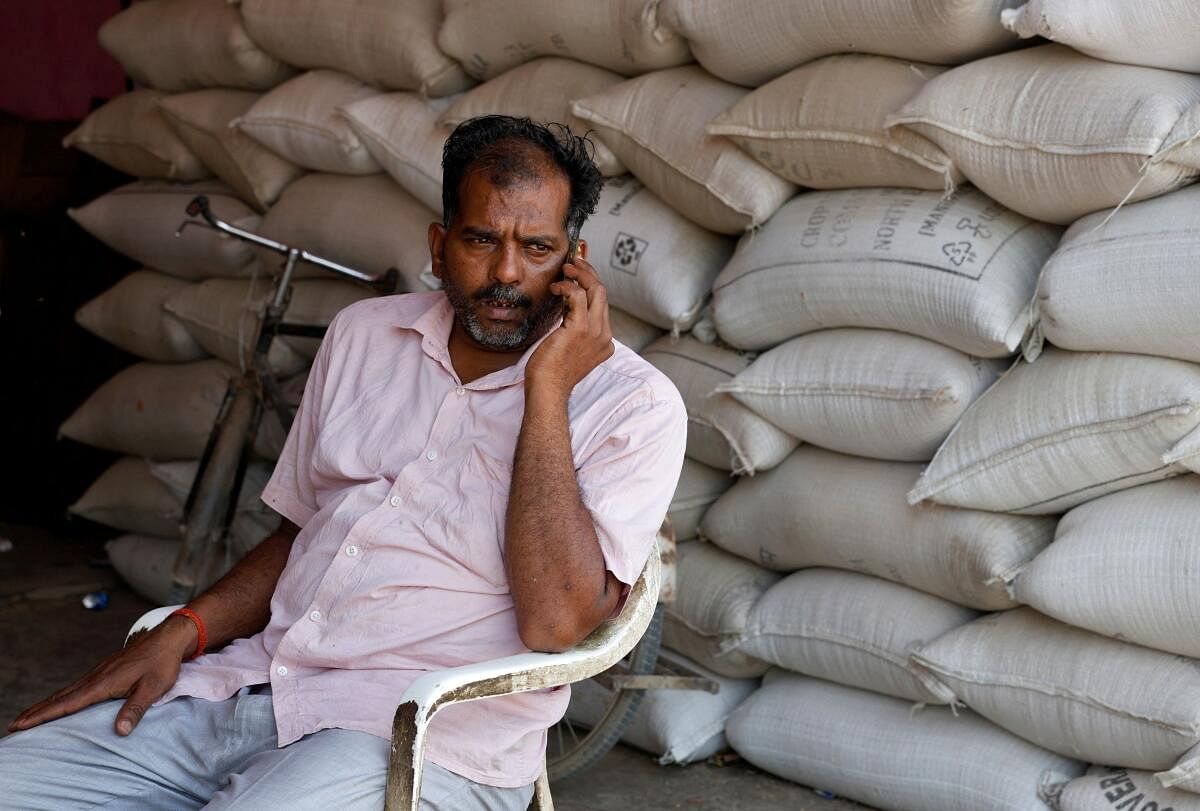 Sanjay Kumar, 32, a farmer, speaks on his mobile phone at a wholesale grain market in Mathura.