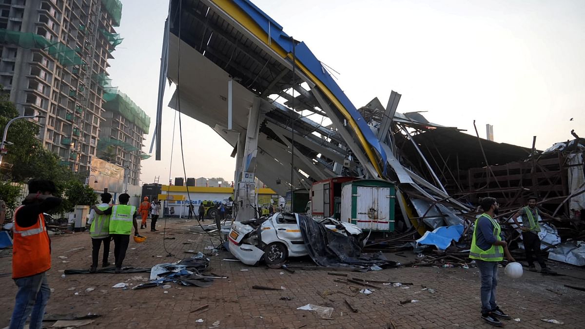 Members of rescue teams at the damaged fuel station after a massive billboard fell in Mumbai.