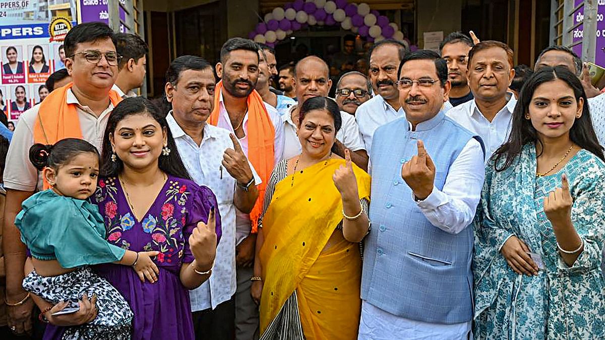 Union Minister and BJP leader Pralhad Joshi and his family members show their inked fingers after casting their vote during the third phase of Lok Sabha polls, in Hubballi.