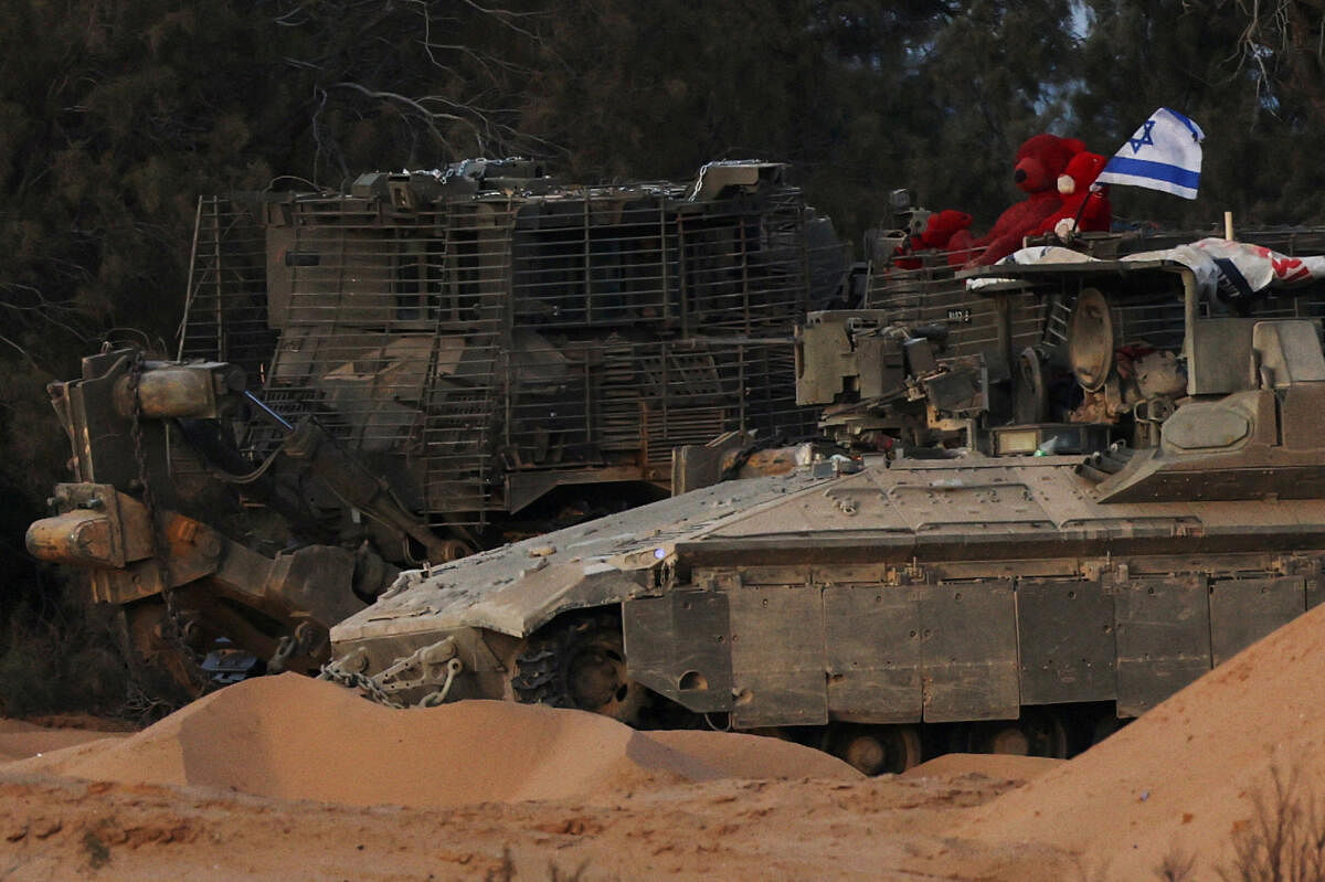 Israeli military armored vehicles sit in a staging area near the Kerem Shalom border crossing, as military operations continue in the southern Gaza city of Rafah, in Kerem Shalom, Israel, May 17, 2024.