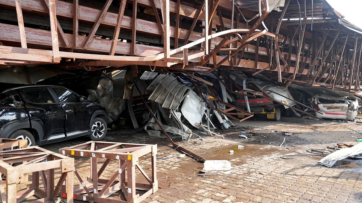 Vehicles are seen trapped under the debris after a massive billboard fell during a dust storm in Mumbai.