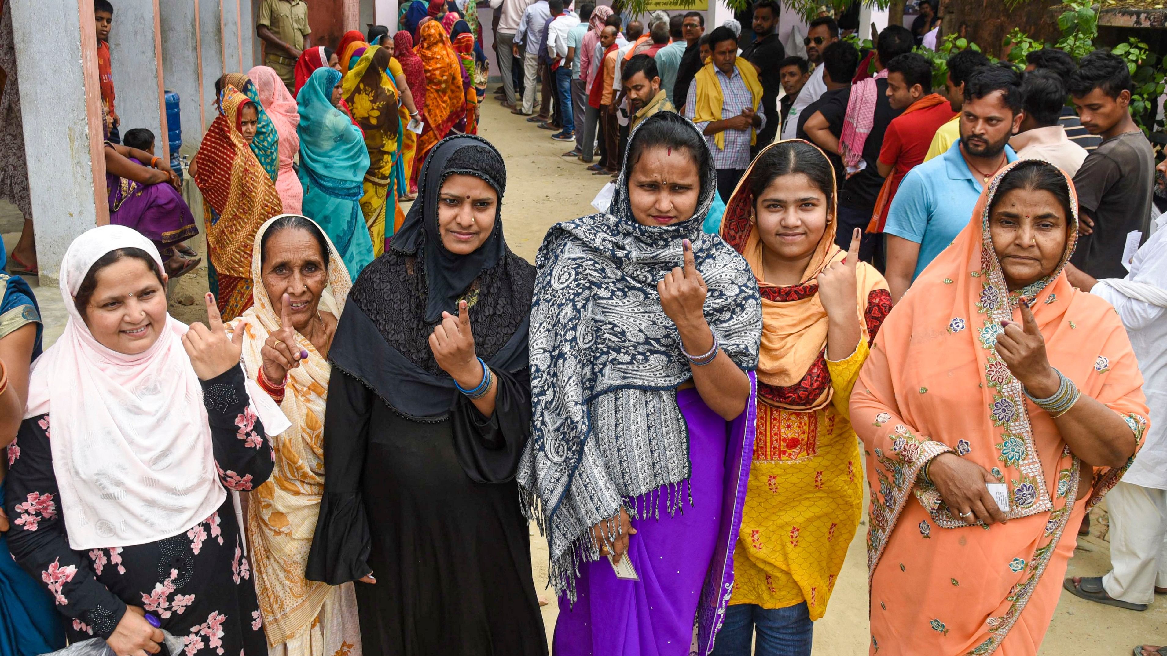 Women show their inked fingers after voting during the fifth phase of Lok Sabha elections in Saran, Bihar.