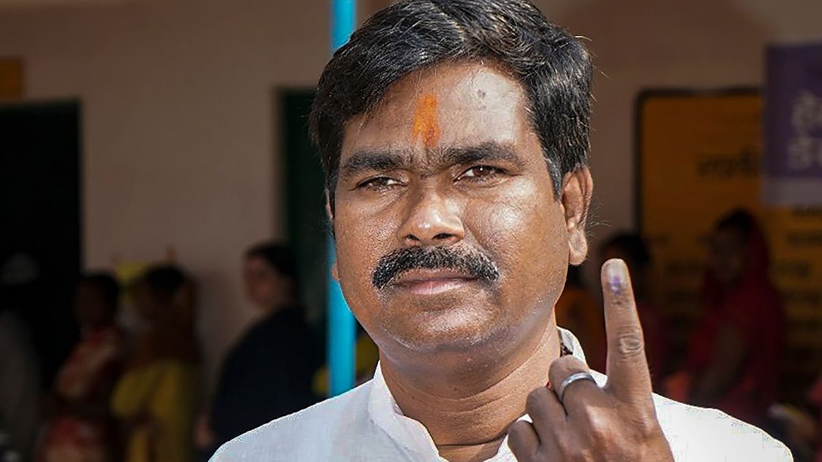 BJP candidate Samir Oraon shows his inked finger after casting his vote during during the fourth phase of Lok Sabha polls, in Lohardaga district of Jharkhand.