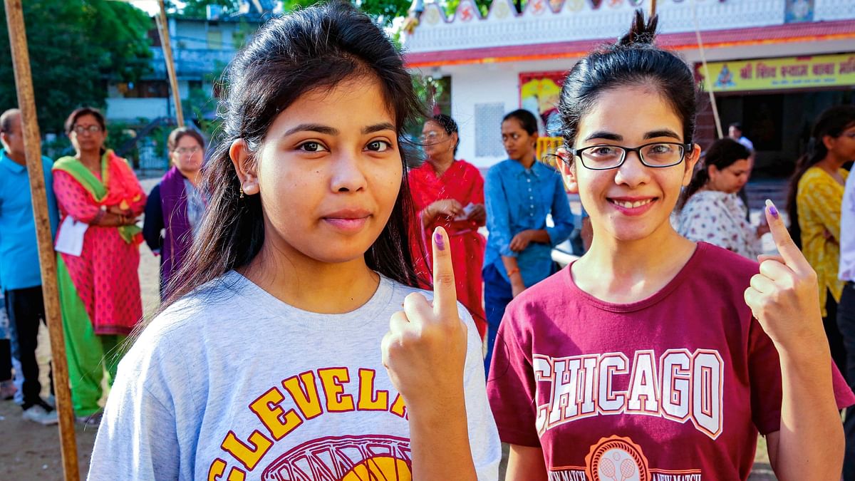 Young voters show their fingers marked with indelible ink after casting their vote for the third phase of Lok Sabha elections, in Bhopal.