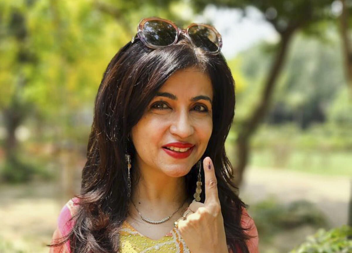 Renowned singer and composer Shibani Kashyap flashes her ink-marked finger after casting her vote.