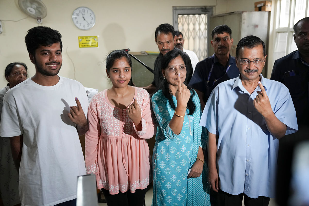 Chief Minister Arvind Kejriwal, wife Sunita Kejriwal and other family members show their fingers marked with indelible ink after casting vote at a polling station, during the sixth phase of Lok Sabha elections, in New Delhi, on Saturday.