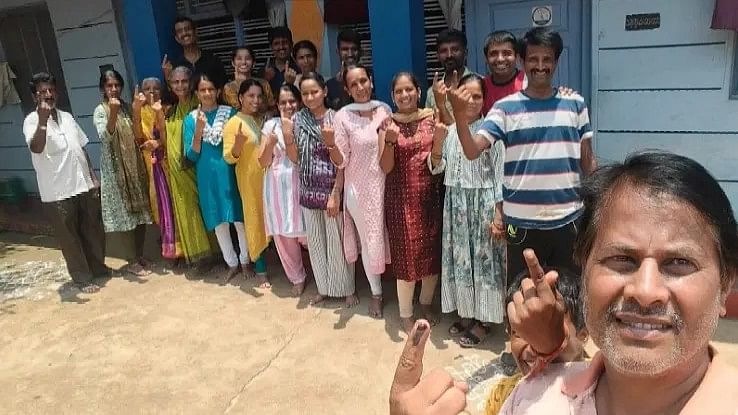 TR Hugar and family members show their inked finger after casting their votes at Nandigavi in Harihar taluk of Davangere district.