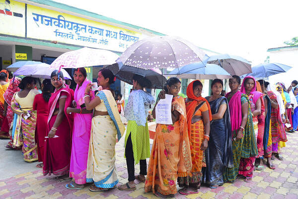 Voters wait to cast their votes for the sixth phase of Lok Sabha elections, on the outskirts of Ranchi in Jharkhand on Saturday.