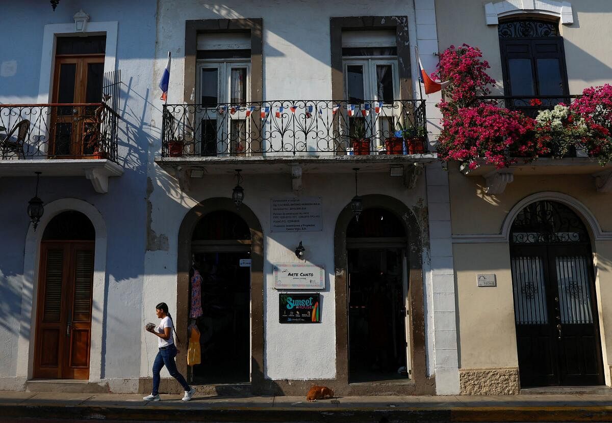 A woman walks along a sidewalk at the old town known as "Casco Antiguo", a day before general election, in Panama City, Panama.
