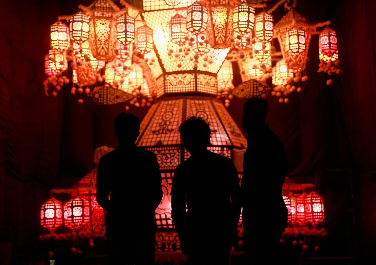 People look at a pandal, a temporary platform to be decorated with illuminated panels illustrating episodes from the life of Buddha, on Vesak Day, an annual celebration of Buddha's birth, enlightenment and death, at the Kelaniya temple in Colombo, Sri Lanka May 23, 2024.