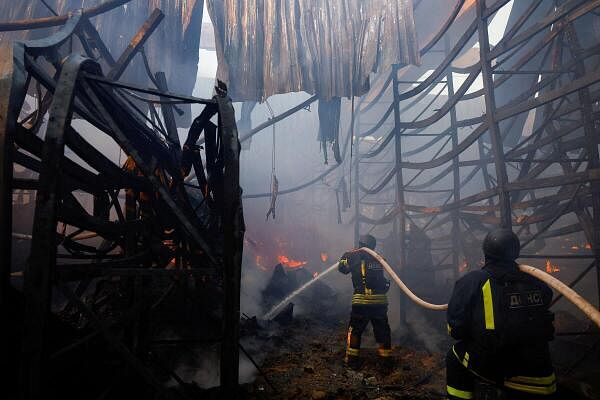 Firefighters work at the site of a household item shopping mall which was hit by a Russian air strike, amid Russia's attack on Ukraine, in Kharkiv, Ukraine, May 25