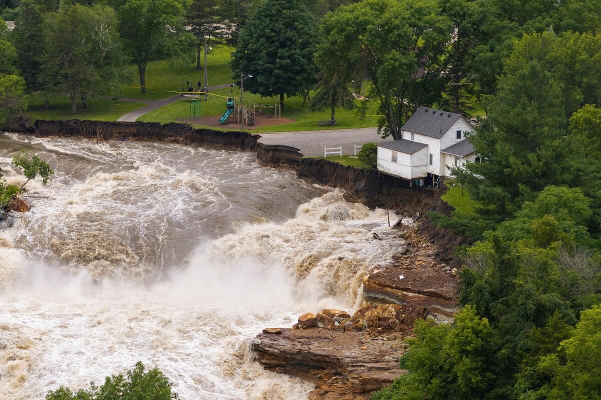 A drone view shows debris accumulating on the Rapidan Dam after torrential rains caused the Blue Earth River to swell, southwest of Mankato, Minnesota, US June 25, 2024.