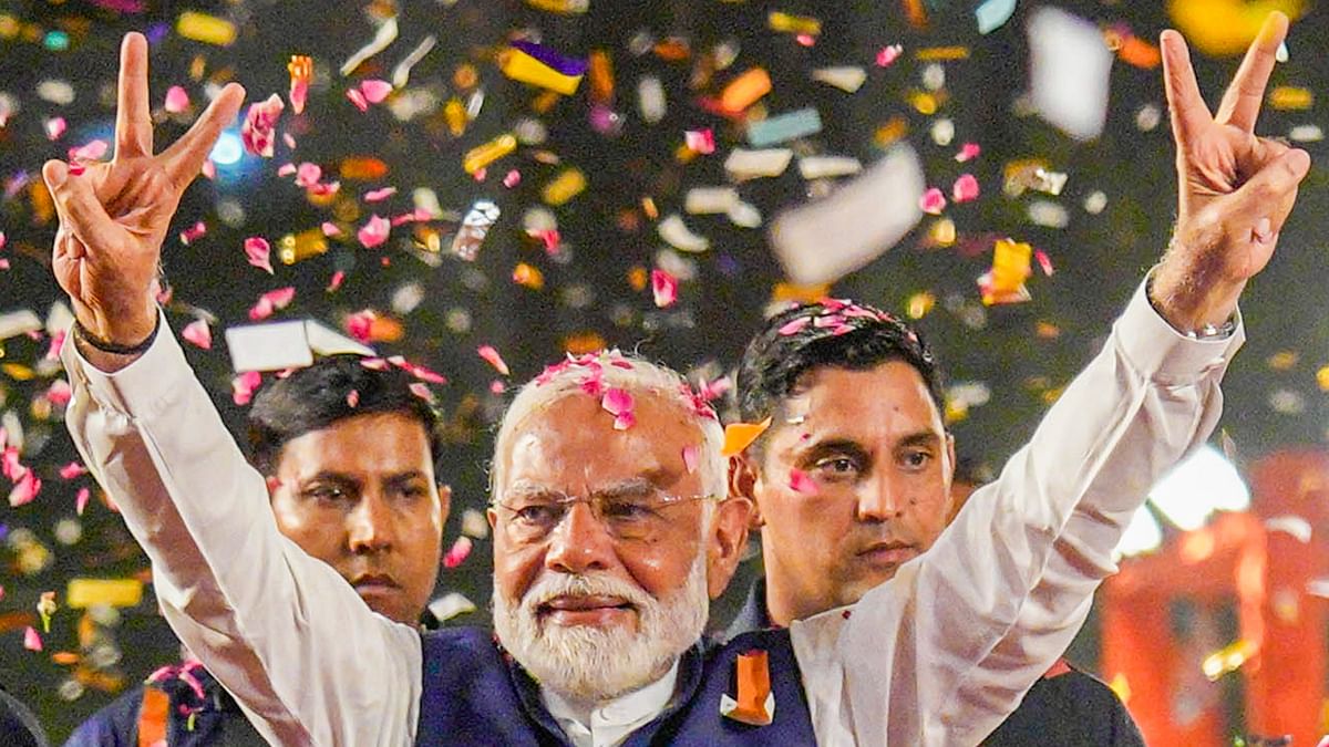 Prime Minister Narendra Modi greets supporters upon his their arrival for a meeting at the party headquarters as the party leads in the Lok Sabha elections amid the counting of votes, in New Delhi.