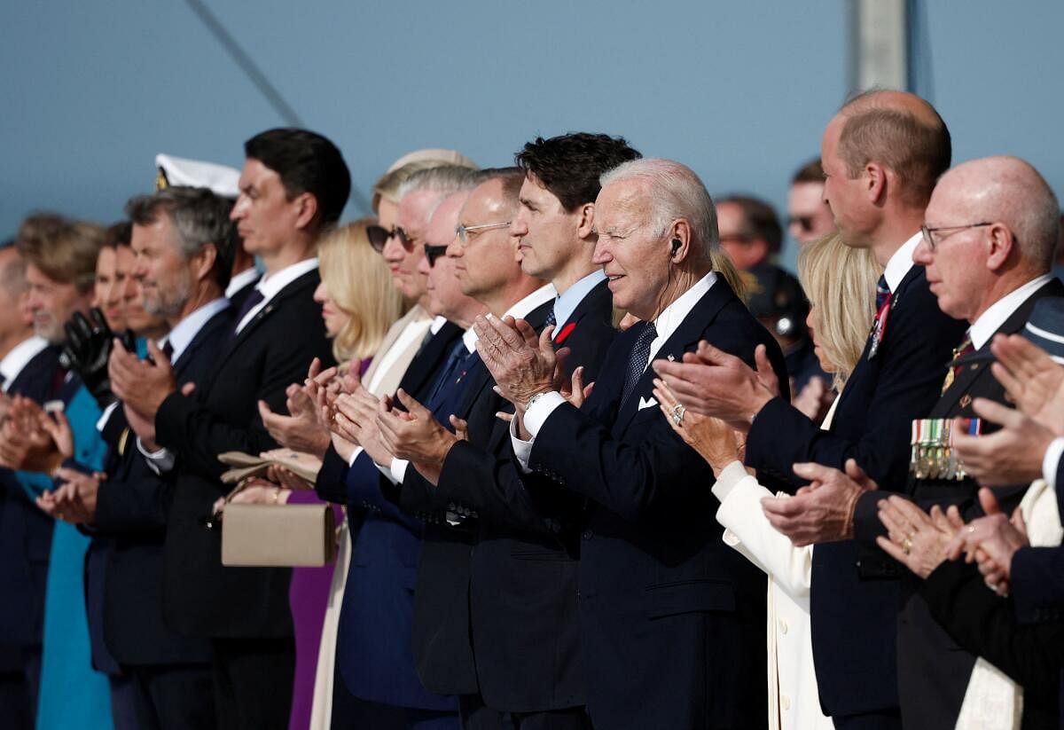 Slovakia's President Zuzana Caputova, Belgium's King Philippe and Queen Mathilde, Prince Albert II of Monaco, Poland's President Andrzej Duda, Canada's Prime Minister Justin Trudeau, U.S. President Joe Biden, and Britain's Prince William, the Prince of Wales applaud during the international ceremony marking the 80th anniversary of the 1944 D-Day landings and the liberation of western Europe from Nazi Germany occupation, at Omaha Beach in Saint-Laurent-sur-Mer, Normandy region, France, June 6, 2024.