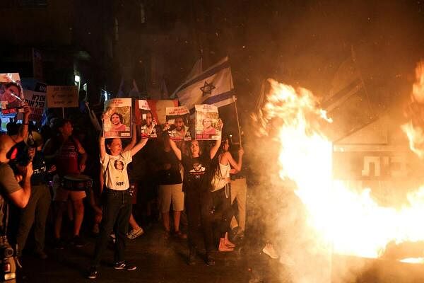 People protest during a day of strike and resistance amid the Israel-Hamas conflict outside the residence of Israeli Prime Minister Benjamin Netanyahu in Jerusalem, June 27, 2024.