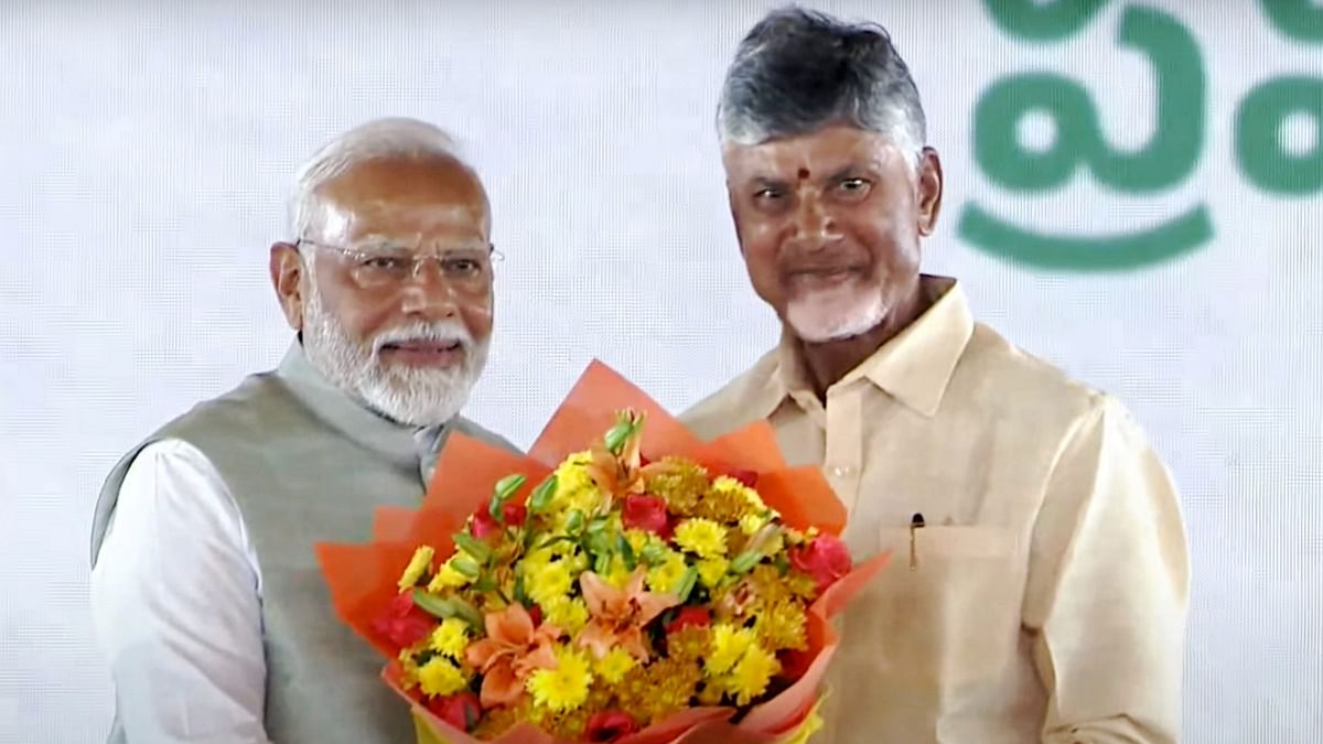 Prime Minister Narendra Modi greets Naidu after he was sworn-in as the Chief Minister of Andhra Pradesh, at a ceremony in Vijayawada.