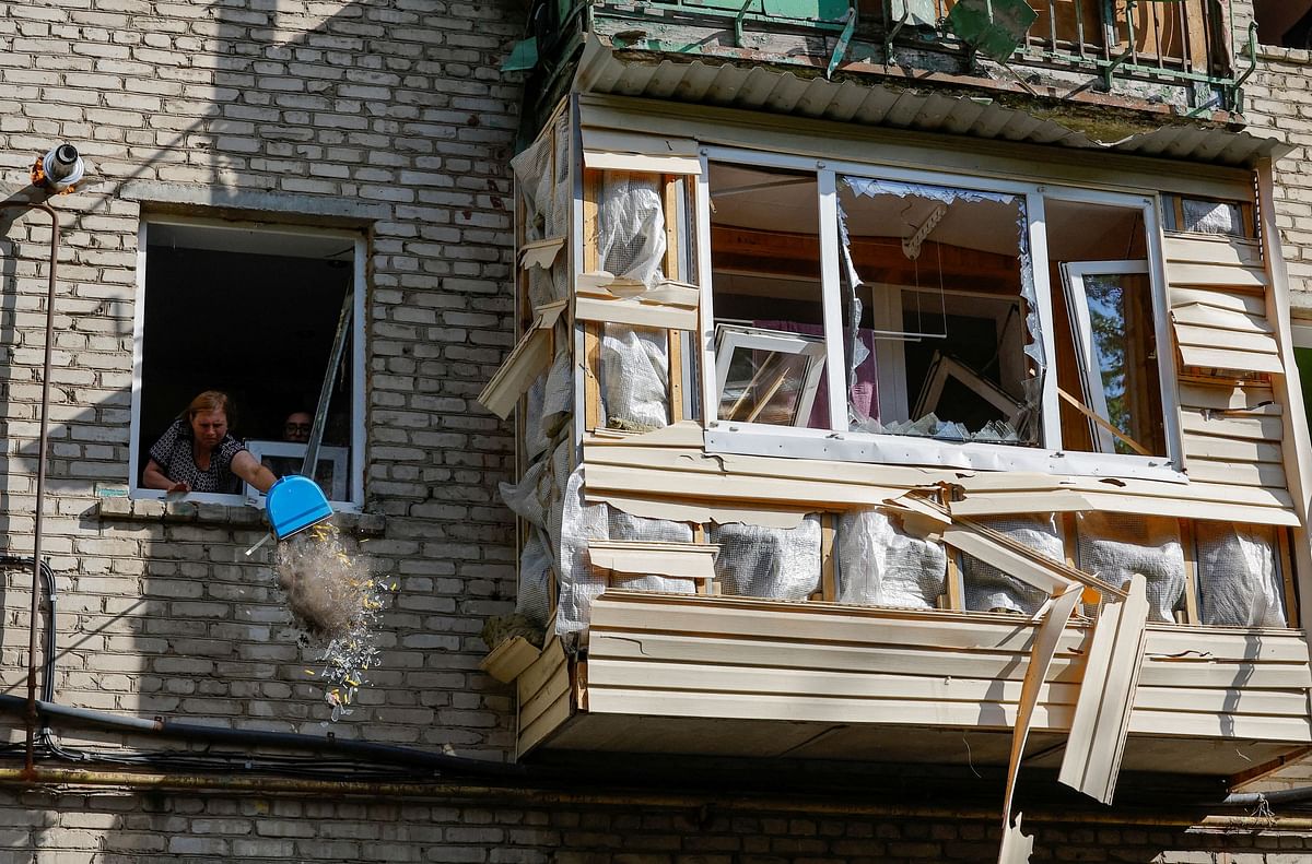 A woman cleans debris from an apartment in a multi-storey residential building damaged in recent shelling by U.S.-supplied ATACMS missiles, according the Russian Defence Ministry, in the course of Russia-Ukraine conflict in Luhansk, Russian-controlled Ukraine, June 7, 2024. 