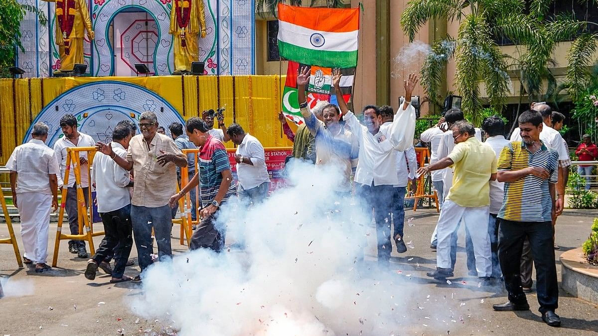 DMK supporters burst firecrackers as they celebrate party's lead during counting of votes for Lok Sabha elections, at party headquarters, Anna Arivalayam, in Chennai