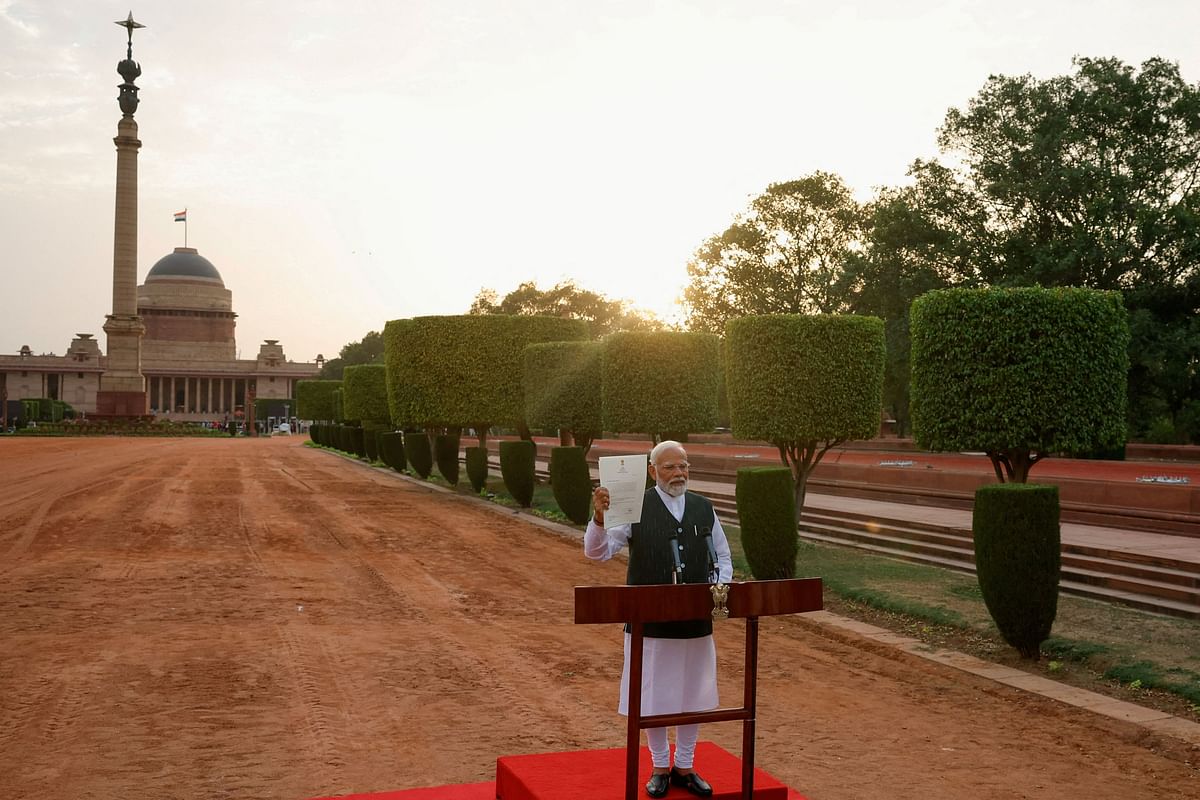 Prime Minister Narendra Modi shows the media a letter that he received from  President Droupadi Murmu inviting him to form a new government after meeting her at the Presidential Palace in New Delhi, June 7, 2024.