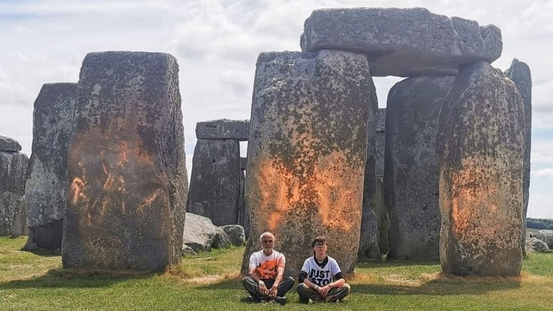 Two climate protesters who sprayed orange substance on the ancient Stonehenge monument in southern England were arrested on June 19.