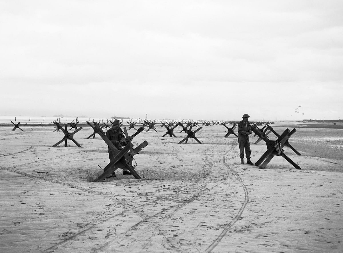 Royal Navy Commandos at La Riviere preparing to demolish two of the many beach obstacles designed to hinder the advance of an invading army, June 6, 1944.