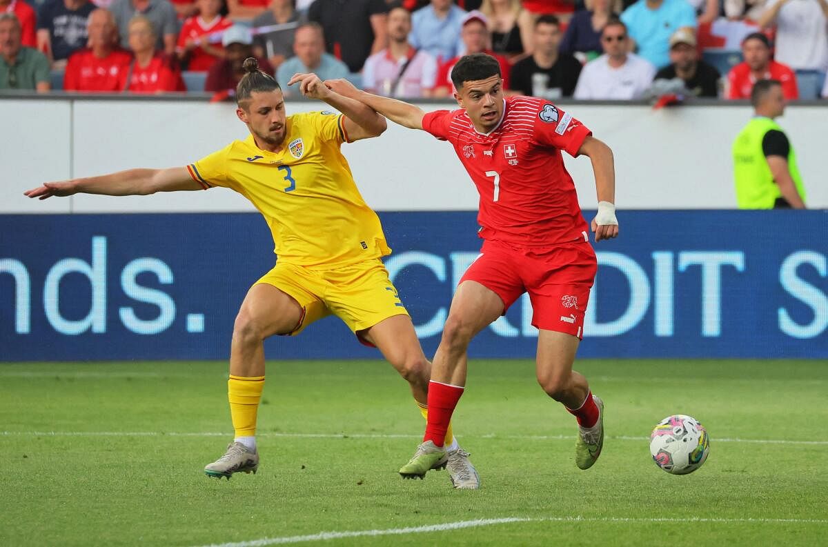 Romania's Radu Dragusin (L) in action.