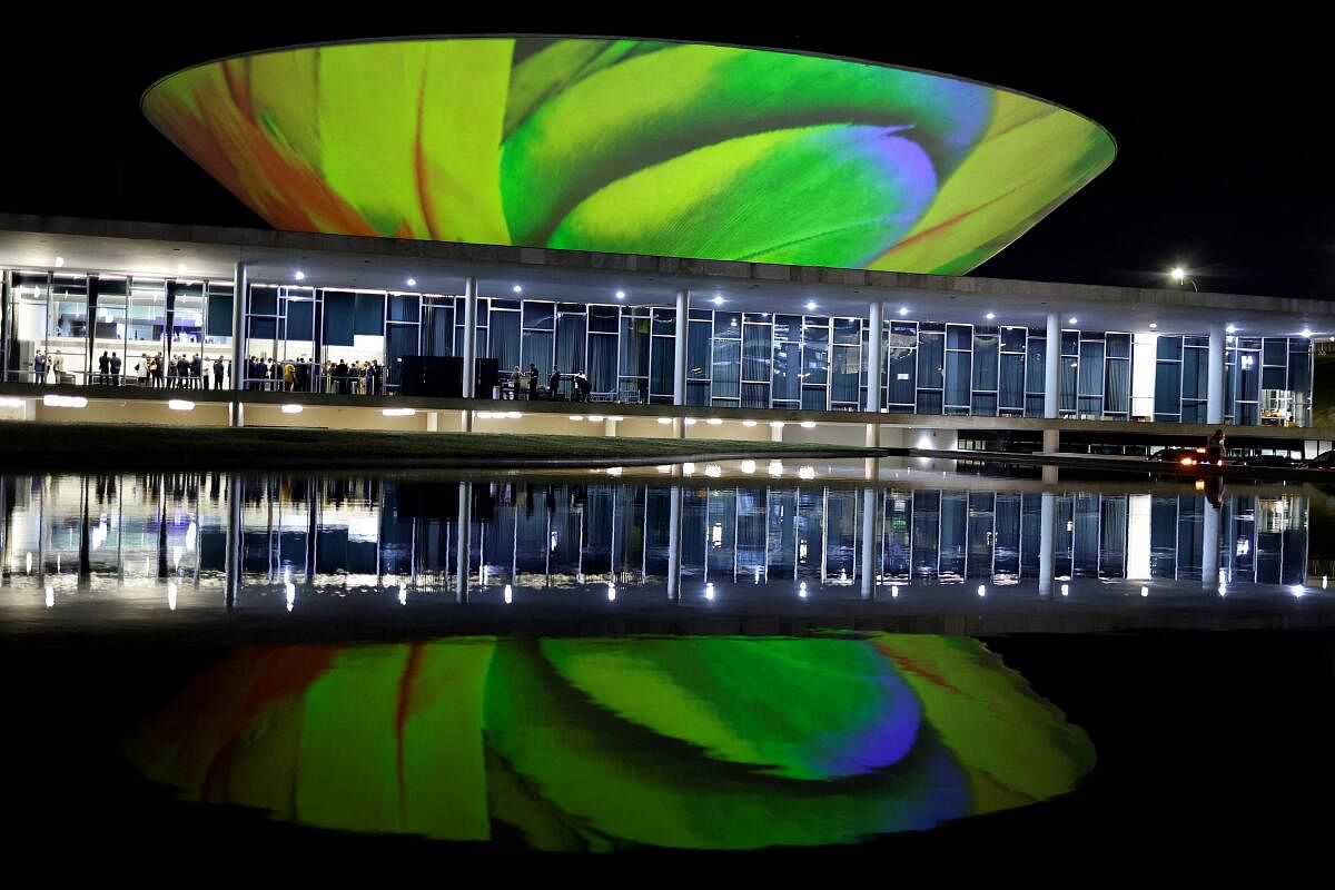 A photograph of the macaw feathers is projected on the National Congress building as part of the events to commemorate World Environment Day, in Brasilia, Brazil, Brazil, June 5, 2024.