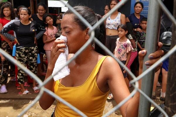 A migrant woman reacts at the migrant reception station during a visit by Panama's president-elect Juan Raul Mulino (not pictured) in Lajas Blancas, Darien province, Panama, June 28, 2024. 