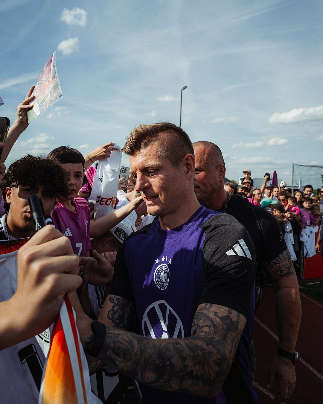 Toni Kroos signing autographs for German fans.