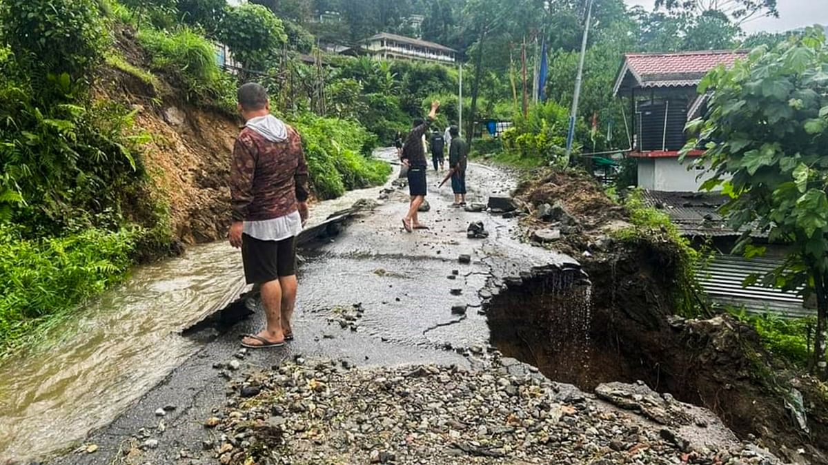 Section of a road damaged due to landslides triggered by incessant rainfall, at Mangan in North Sikkim.